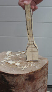 person holding a piece of wood cut in the outline of a spatula with wood&hellip;